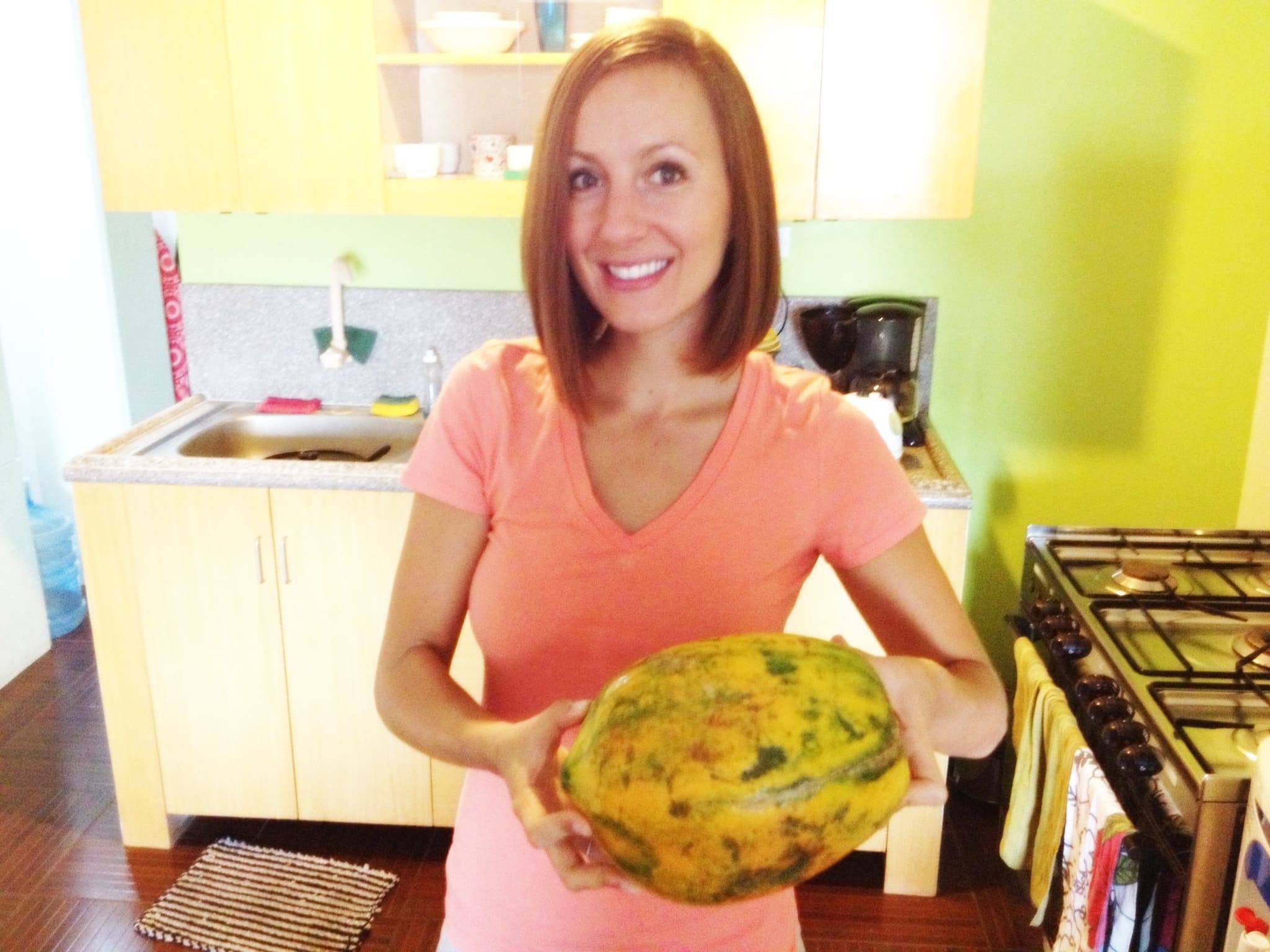 Woman holding a papaya.