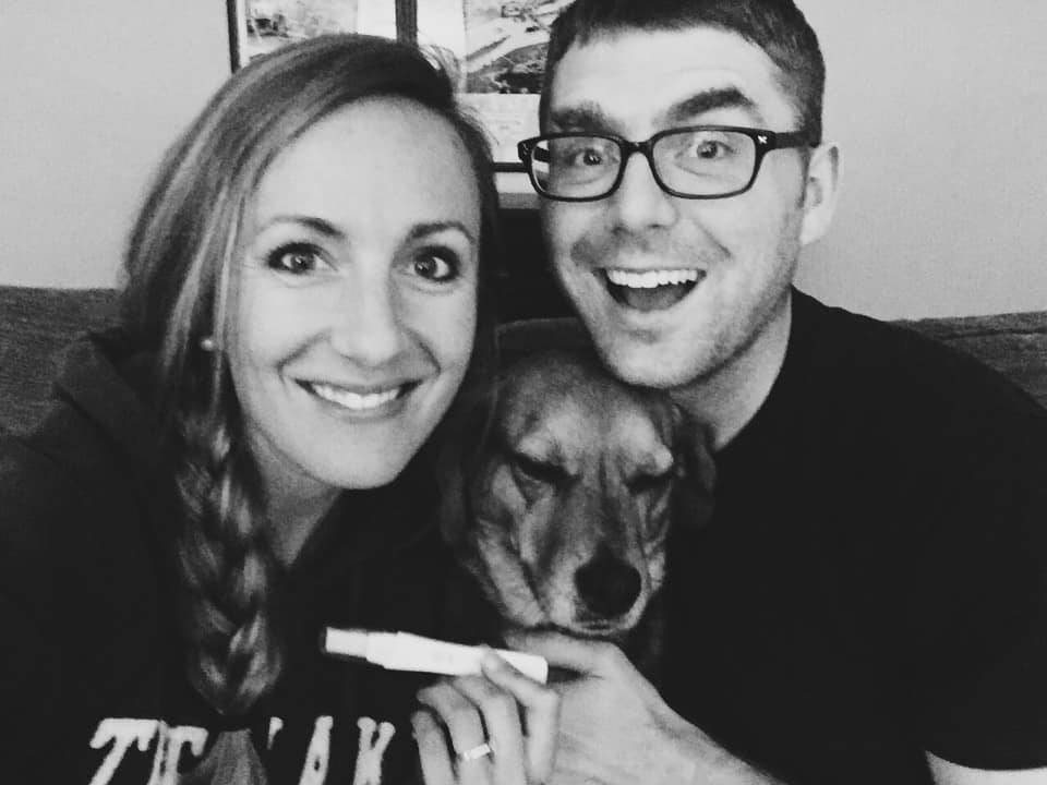 A happy couple with their dog.