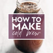 Image of a mason jar filled with coffee grounds and water steeping to make cold brew. There's text over the jar that says "How to Make Cold Brew"