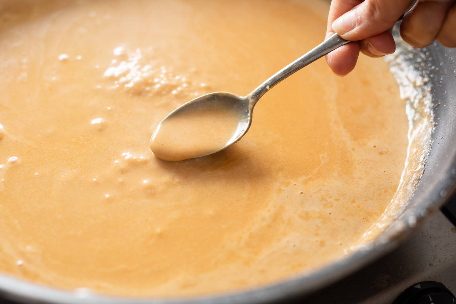 Ramen broth in a skillet.