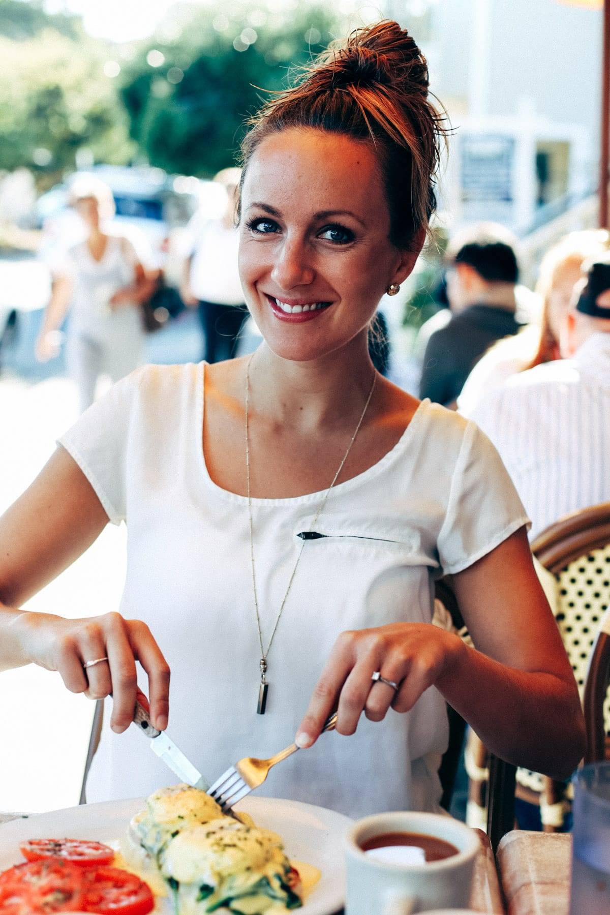 Woman cutting into food.